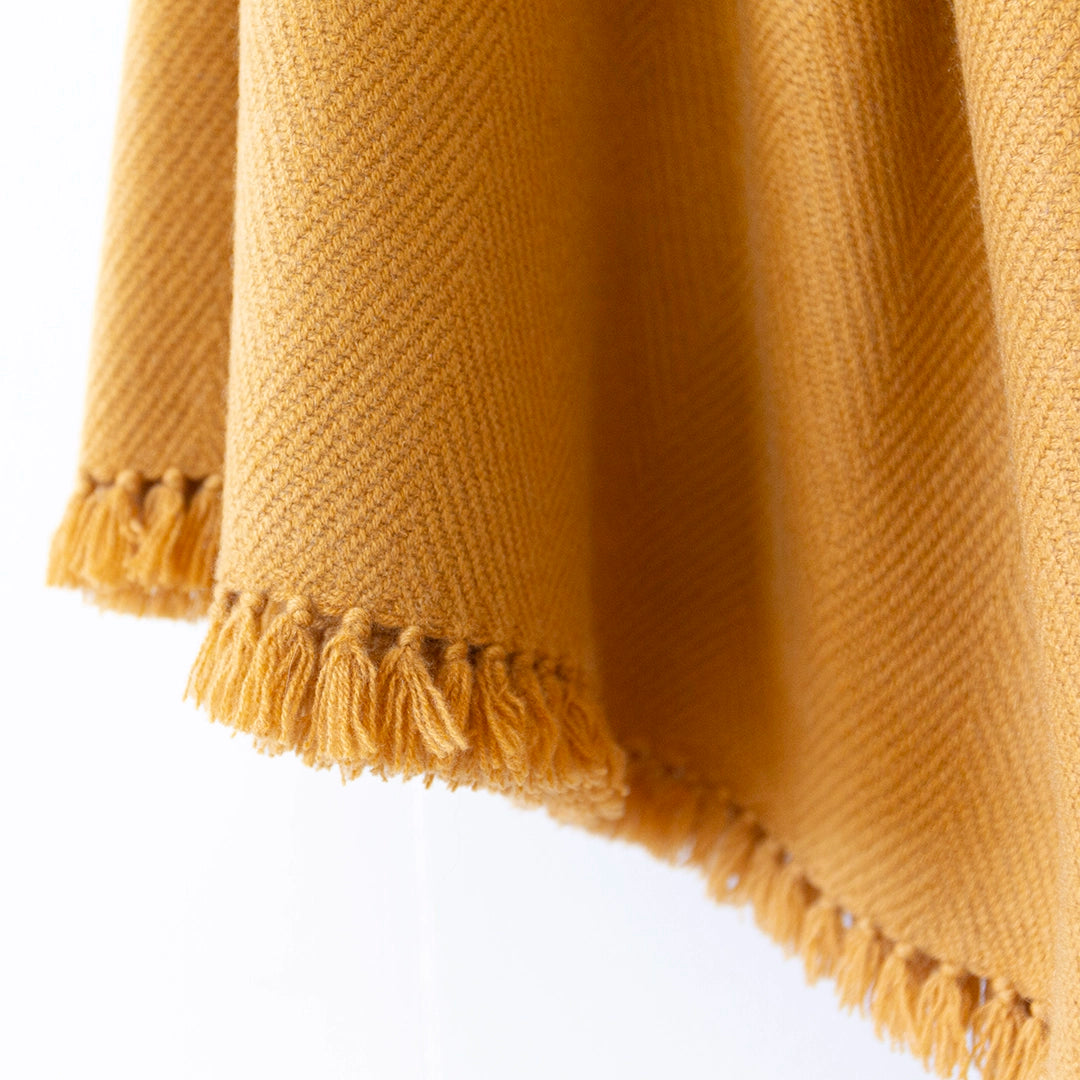 Close-up of Nantucket Looms chai cashmere throw blanket showing the weave and fringe.