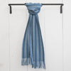 Elegant Nantucket Looms alpaca throw in a chic light blue hue, casually hung on a black rod, embodying the relaxed sophistication of Nantucket style.