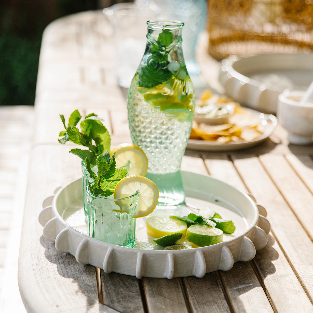 Introduce a unique and artistic element to your dining experience with the Sculptural Tray Fish Carafe from Nantucket Looms. This beautifully crafted piece combines functional design with exceptional craftsmanship, making it a perfect addition to any table setting.